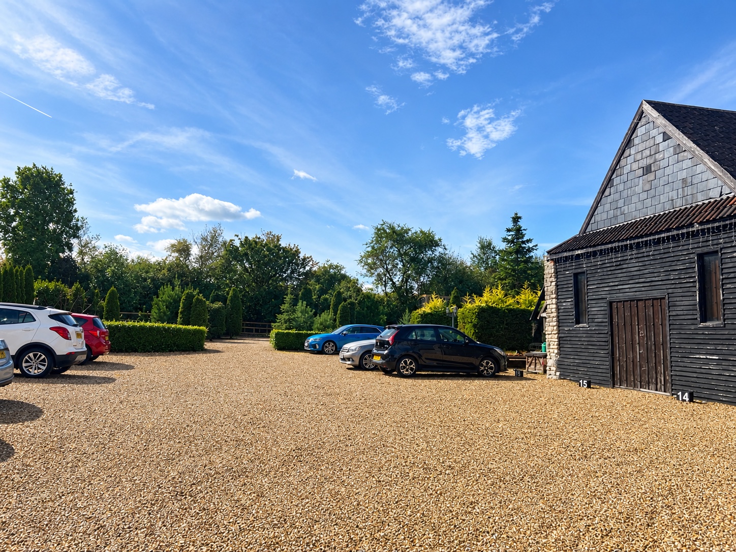 Wide view of the gravel parking courtyard at Colliters Brook Farm